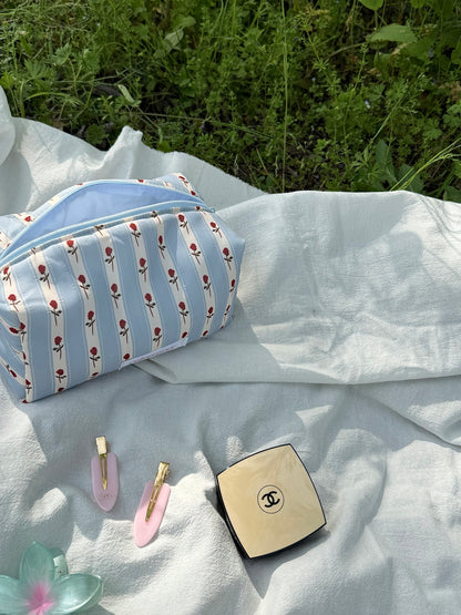A soft blue makeup bag with rose stripes, ready for your daily essentials, Colorcarry