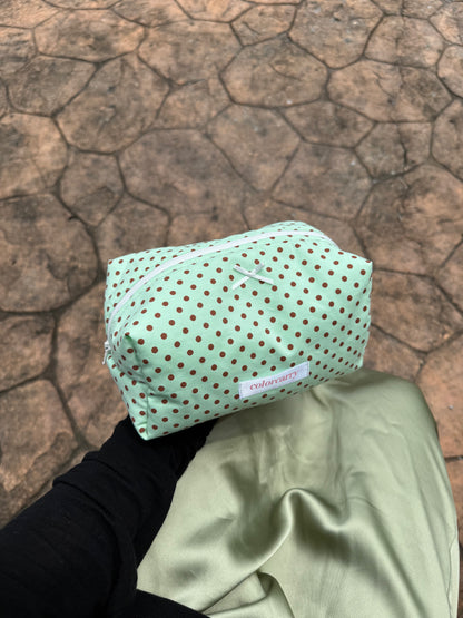 Playful mint green pouch with brown dots, casually placed for daily use, Colorcarry