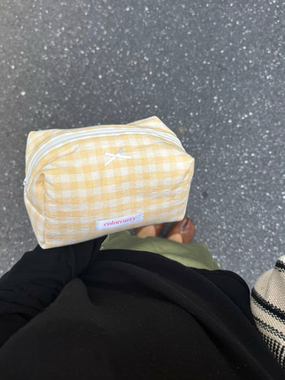 Yellow Gingham Cotton Makeup Pouch in everyday use, showing soft gingham pattern, Colorcarry