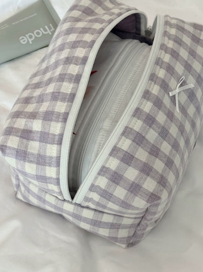 Soft purple check pouch styled in an everyday lifestyle scene