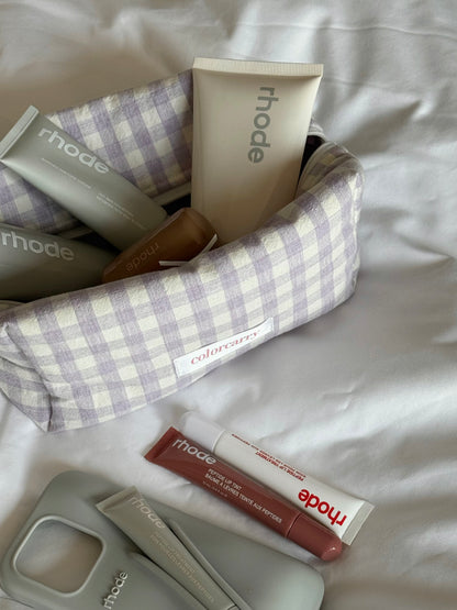 Purple gingham makeup bag in a cozy daily setting